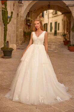 Ball gown wedding dress with 3D floral lace V-neck bodice and layered tulle skirt with leaf appliqués.