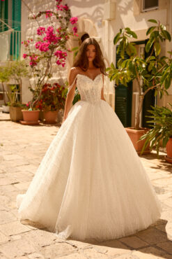 Ball gown wedding dress with crystal beaded sweetheart corset bodice, pearl strand straps, and glitter tulle skirt.