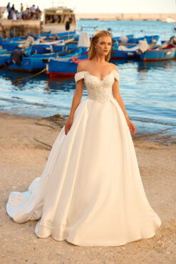 Ball gown wedding dress with beaded sweetheart bodice, off-the-shoulder cap sleeves, and full satin skirt with cathedral train.